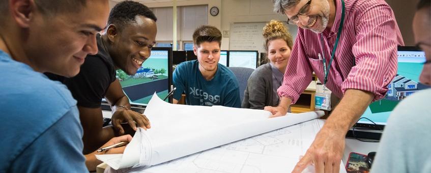 Architectural Engineering students looking at blueprints with their instructor at the Georgetown Campus.