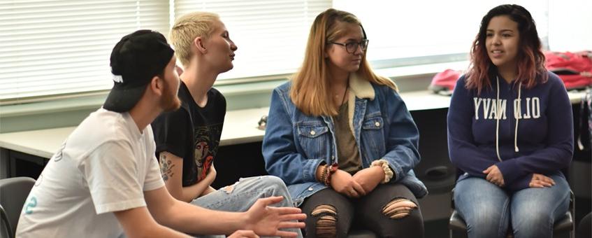 Four Human Services students sitting together in a classroom.